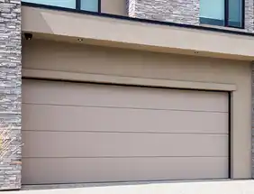 Taupe-colored Wayne Dalton 9605 flush panel steel garage door with minimalist modern design.